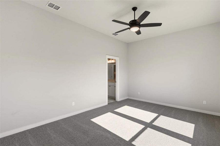 Spare room featuring carpet floors and a ceiling fan