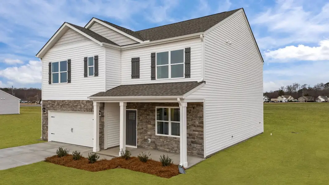 Front exterior of a new home in Ridgewood Farms, Winterville, NC, highlighting curb appeal (Image 21). Front exterior of a new home in Ridgewood Farms, Winterville, NC, highlighting curb appeal (Image 21).
