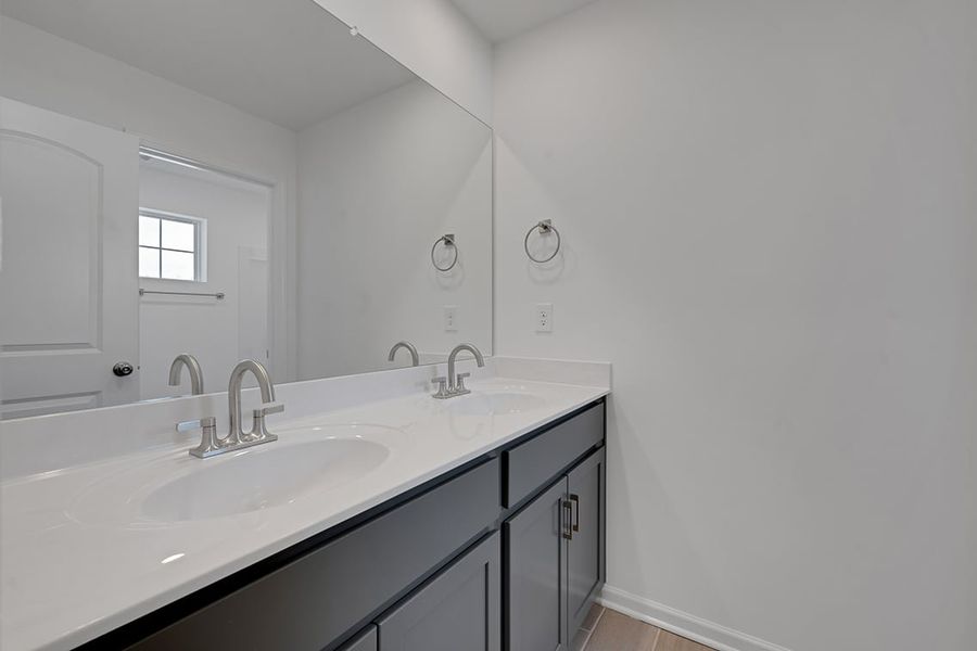 A bathroom with a large mirror.