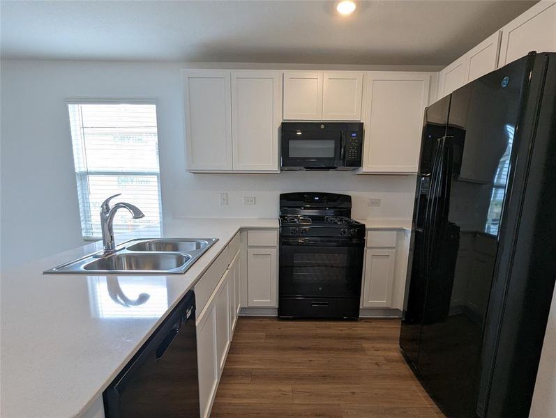 A well-appointed kitchen showcasing elegant counters and contemporary appliances.
