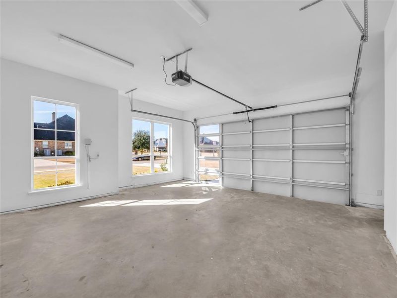 Garage with a garage door opener and sealed concrete. Garage with a garage door opener and sealed concrete.