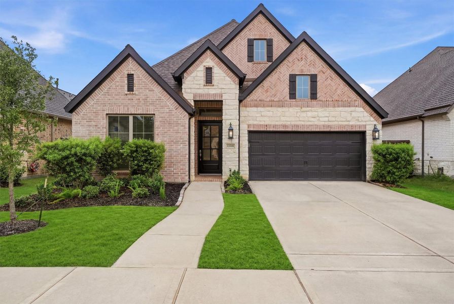 Front exterior of a new home in Riceland, Mont Belvieu, TX, highlighting curb appeal (Image 1). Front exterior of a new home in Riceland, Mont Belvieu, TX, highlighting curb appeal (Image 1).