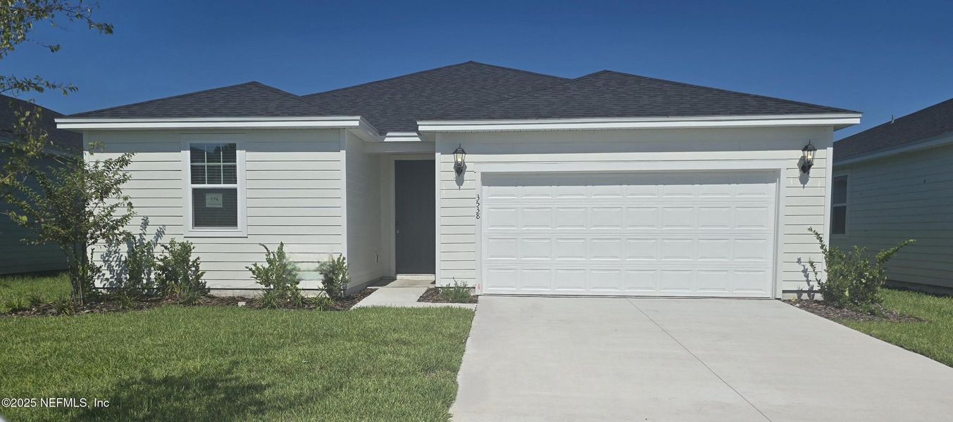 Front exterior of a new home in Lakes at Bella Lago - Signature Series, Green Cove Springs, FL, highlighting curb appeal (Image 17).
