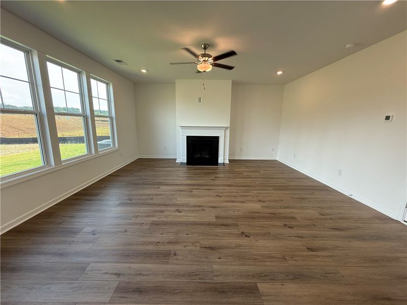 A spacious living area features wide plank laminat A spacious living area features wide plank laminat