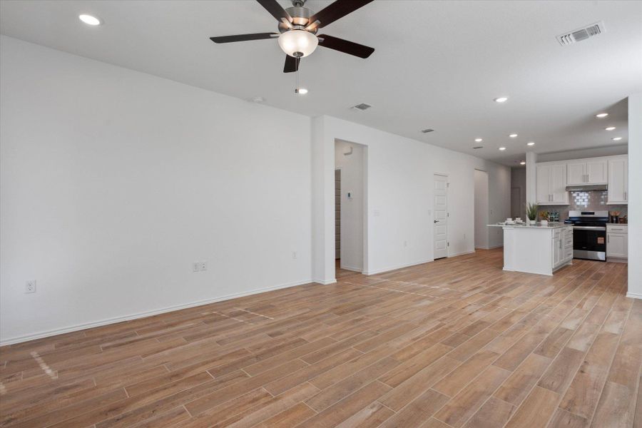 Unfurnished living room with recessed lighting, light wood tile finished floors, and a ceiling fan
