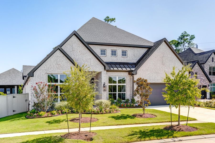 Front exterior of a new home in Audubon 60′, Magnolia, TX, highlighting curb appeal (Image 26). Front exterior of a new home in Audubon 60′, Magnolia, TX, highlighting curb appeal (Image 26).
