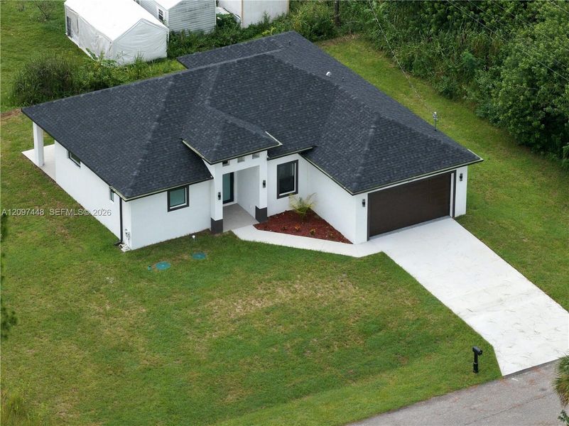 Front exterior of a new home in , Lehigh Acres, FL, highlighting curb appeal (Image 20).