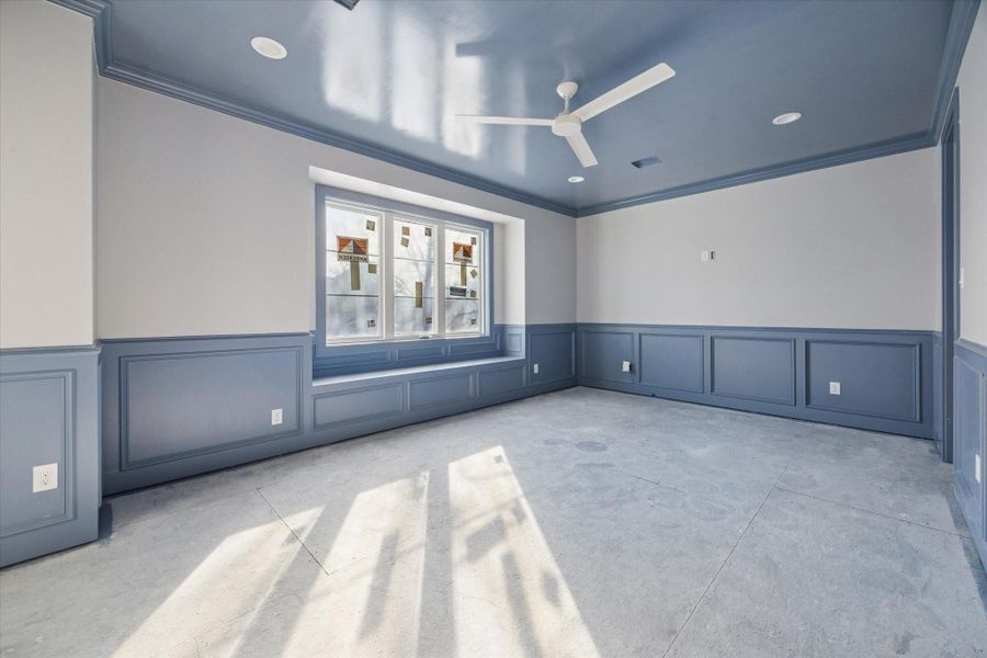 GAME ROOM - A generously sized game room is finished with custom wall paneling, a painted ceiling detail, and abundant natural light, creating a space that feels both elevated and versatile. Ideal for media, play, or secondary living, the room offers flexibility to adapt as needs change while maintaining a cohesive design aesthetic. -- Construction as of 1/5/26