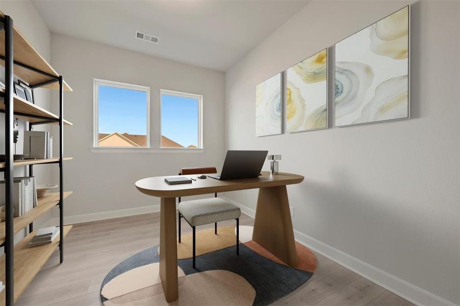 Bright room featuring two windows, light wood-finish flooring, and a built-in shelving unit with black metal framing and wood-finish shelves