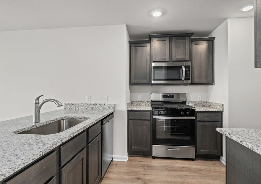 The kitchen has sprawling granite countertops.