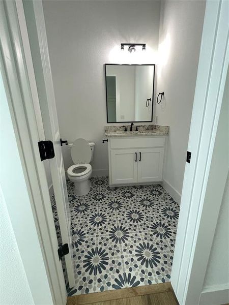 Bathroom featuring toilet and vanity Bathroom featuring toilet and vanity