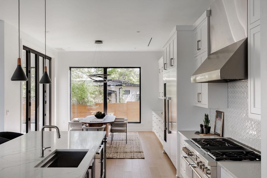 A secondary kitchen perspective emphasizes the scale, storage, and premium appliance package paired with warm wood tones. A secondary kitchen perspective emphasizes the scale, storage, and premium appliance package paired with warm wood tones.