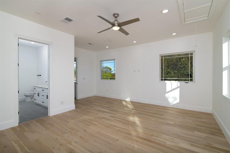 Empty room with light hardwood / wood-style floors and ceiling fan