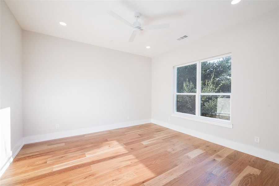 Unfurnished room featuring ceiling fan and light wood-type flooring