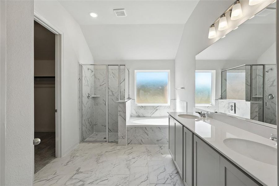 Bathroom with a garden tub, a marble finish shower, double vanity, marble finish flooring, and recessed lighting Bathroom with a garden tub, a marble finish shower, double vanity, marble finish flooring, and recessed lighting