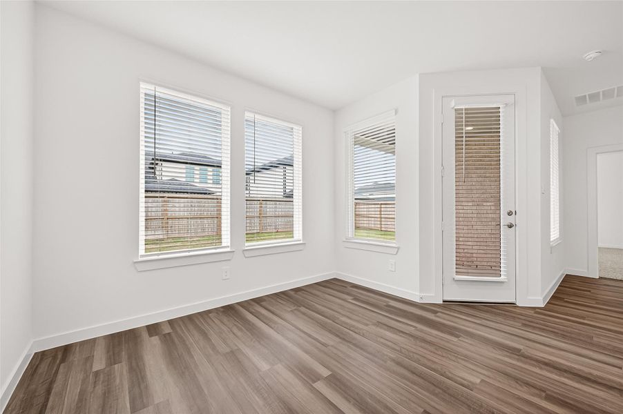 Breakfast Area: The bright breakfast area overlooks the backyard and opens to the covered patio.