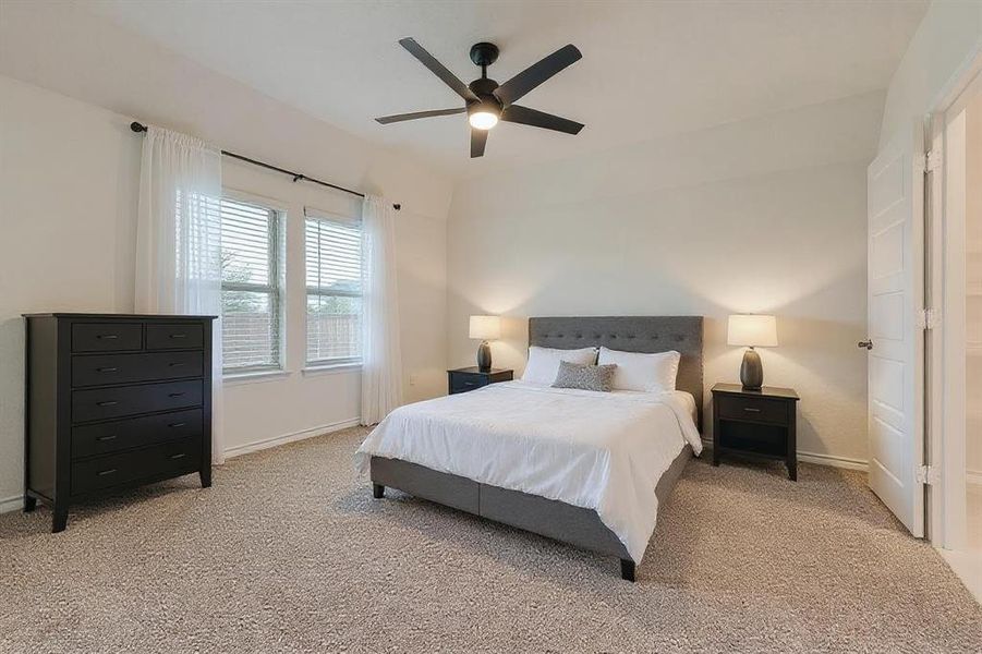 Bedroom featuring light carpet and ceiling fan