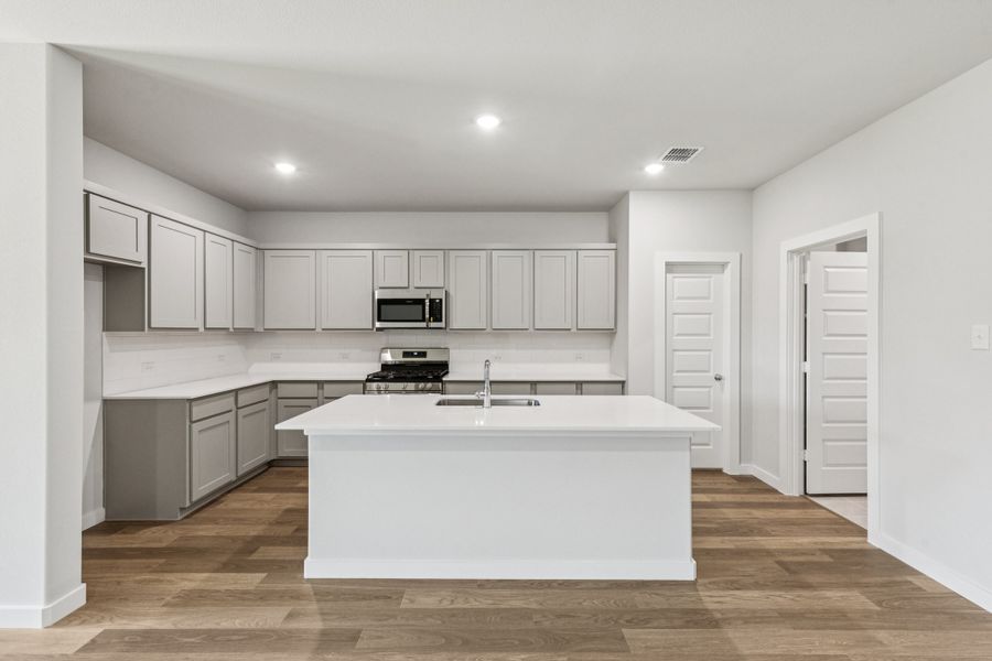 Kitchen in the Oscar home plan by Trophy Signature Homes – REPRESENTATIVE PHOTO Kitchen in the Oscar home plan by Trophy Signature Homes – REPRESENTATIVE PHOTO