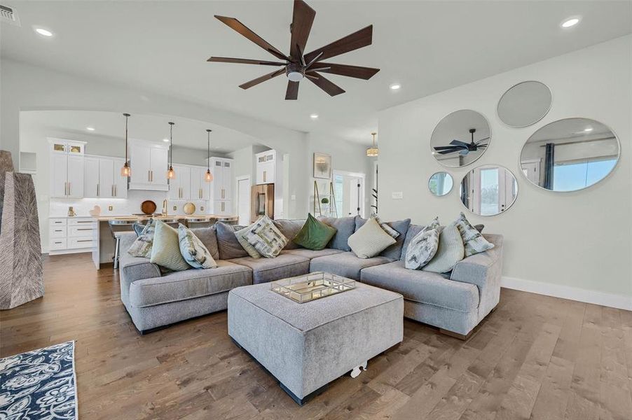 Living room with hardwood / wood-style flooring and ceiling fan