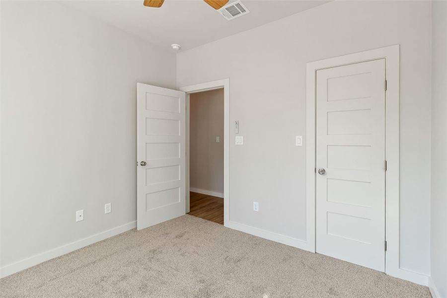 Unfurnished bedroom featuring carpet floors and ceiling fan