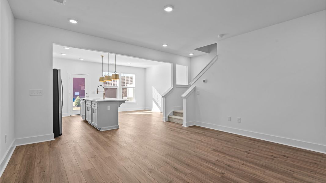 Hardwood flooring and high standards define this vibrant family room ideal for everyday living