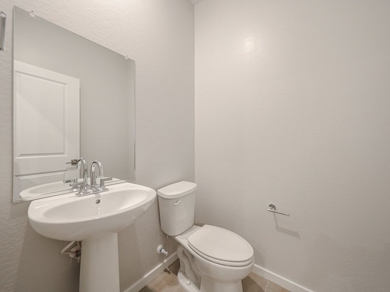A bathroom with a toilet and sink.