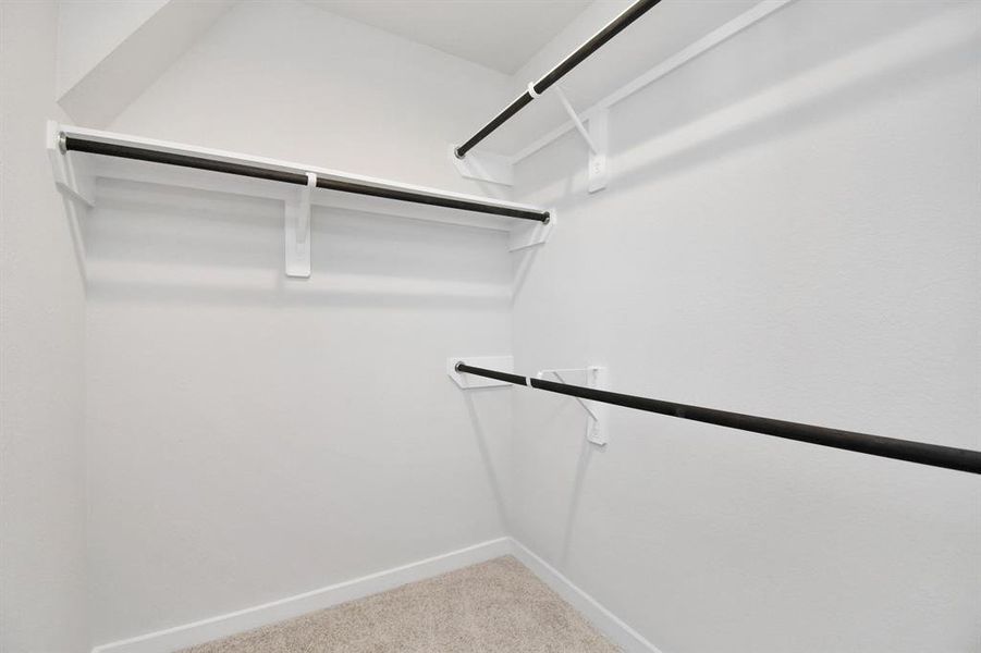 Walk-in closet that epitomizes luxury and practicality.  Sample photo of completed home with similar floor plan. As-built interior colors and selections may vary.