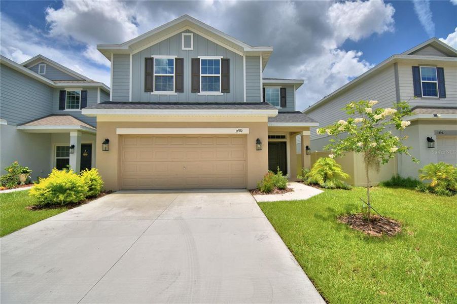 Front exterior of a new home in Villamar, Winter Haven, FL, highlighting curb appeal (Image 1). Front exterior of a new home in Villamar, Winter Haven, FL, highlighting curb appeal (Image 1).