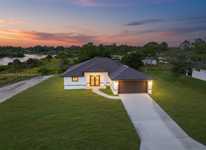 Front exterior of a new home in , Lehigh Acres, FL, highlighting curb appeal (Image 24).