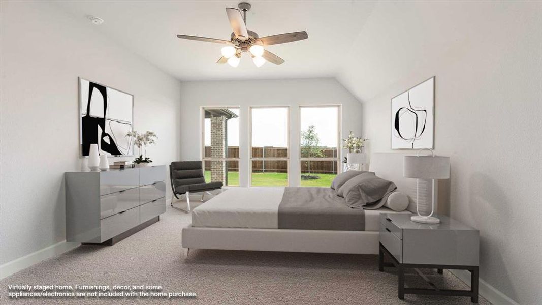 Carpeted bedroom featuring ceiling fan and vaulted ceiling