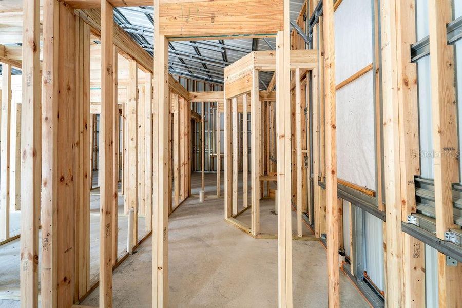 primary bathroom with walk in shower and walk in closet