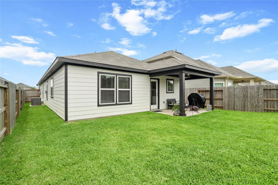 Enjoy outdoor living in the upgraded covered back patio featuring extended space for relaxing or entertaining and a ceiling fan for added comfort year-round.