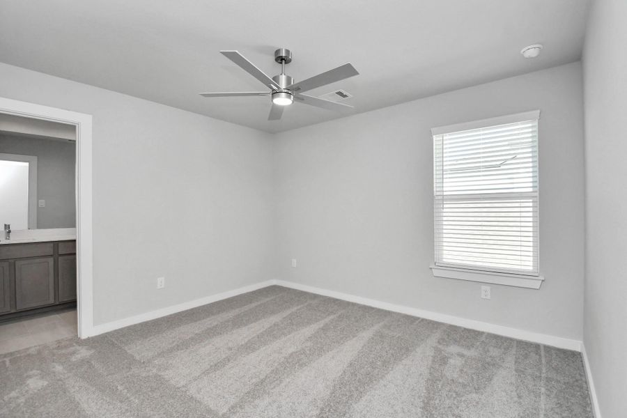 Secondary bedroom features plush carpeting, large windows that let in plenty of natural light, bright paint, and spacious closets. Sample photo of completed home with similar floor plan. Actual colors and selections may vary.