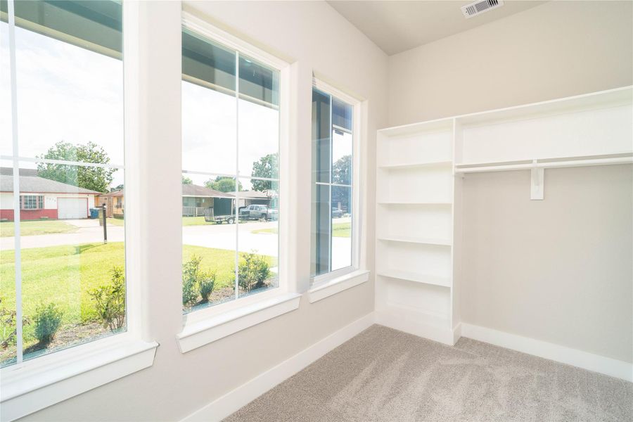How amazing is this primary walk-in closet with built-in shelves and large windows How amazing is this primary walk-in closet with built-in shelves and large windows
