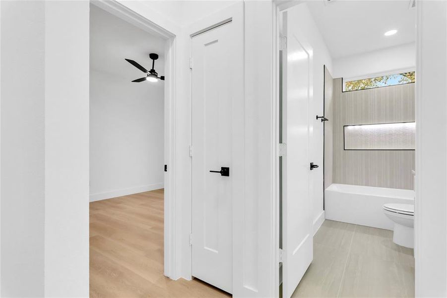 Full bath with toilet and ceiling fan