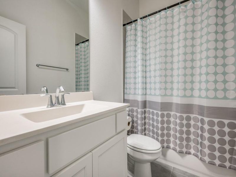 Full bathroom featuring toilet and vanity