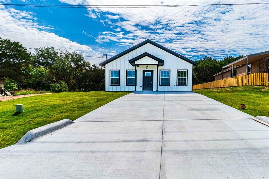 Front exterior of a new home in , Granbury, TX, highlighting curb appeal (Image 16).