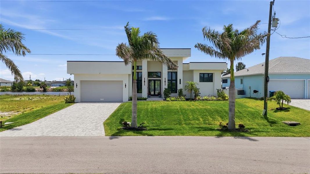 Front exterior of a new home in , Cape Coral, FL, highlighting curb appeal (Image 24).
