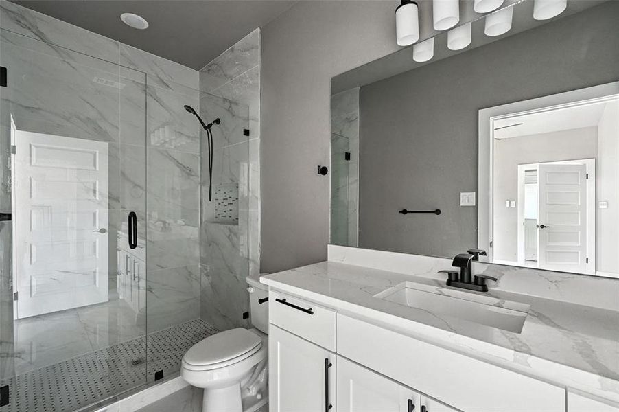 Full bathroom featuring vanity and a marble finish shower Full bathroom featuring vanity and a marble finish shower