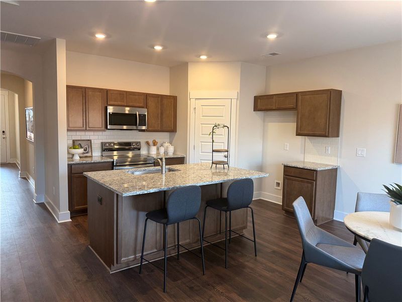 This kitchen features rich cabinetry, sleek stainl