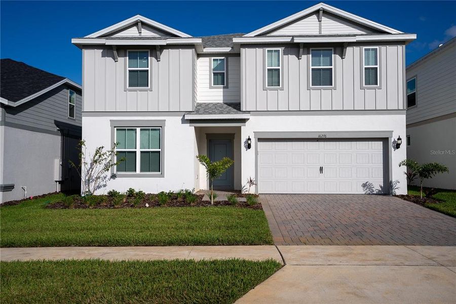 Front exterior of a new home in , Clermont, FL, highlighting curb appeal (Image 1). Front exterior of a new home in , Clermont, FL, highlighting curb appeal (Image 1).