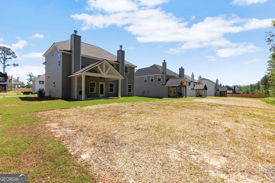 Front exterior of a new home in Juliette Crossing, Forsyth, GA, highlighting curb appeal (Image 1).