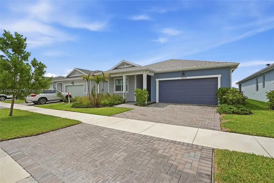 Front exterior of a new home in Tradition, Port St. Lucie, FL, highlighting curb appeal (Image 24).