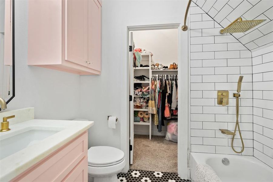 Full bathroom featuring vanity, a spacious closet, tile patterned floors, and bathing tub / shower combination