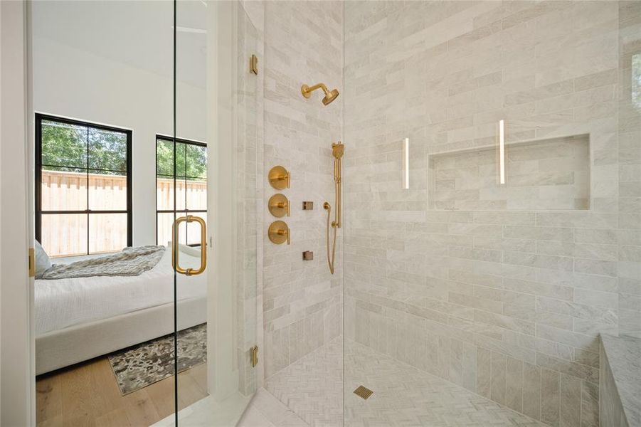 Bathroom featuring a shower stall and ensuite bathroom