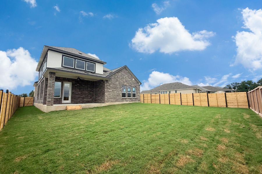 A spacious backyard with fresh green grass, ideal for outdoor activities, enclosed by new wood fencing. A spacious backyard with fresh green grass, ideal for outdoor activities, enclosed by new wood fencing.