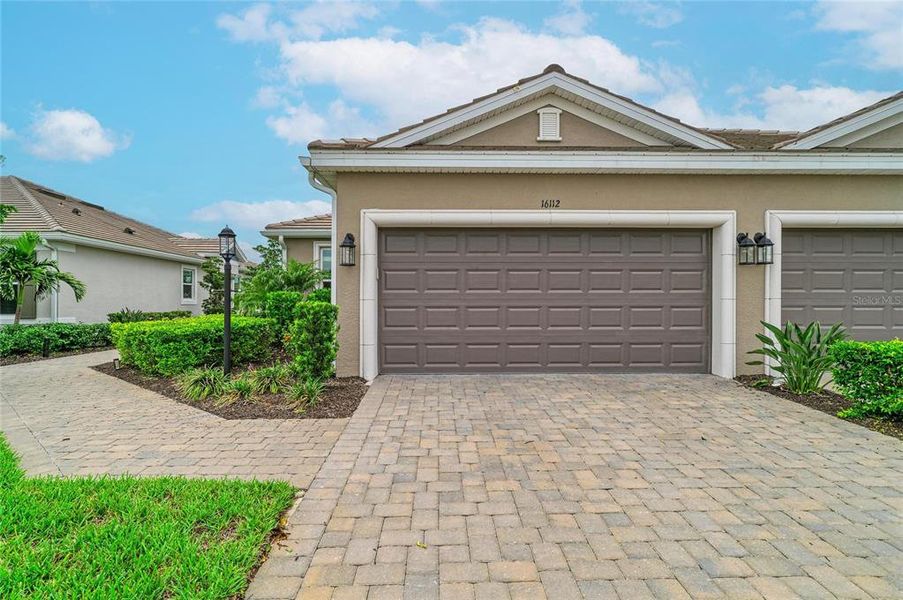 Front exterior of a new home in Esplanade at Azario Lakewood Ranch, Lakewood Ranch, FL, highlighting curb appeal (Image 22). Front exterior of a new home in Esplanade at Azario Lakewood Ranch, Lakewood Ranch, FL, highlighting curb appeal (Image 22).