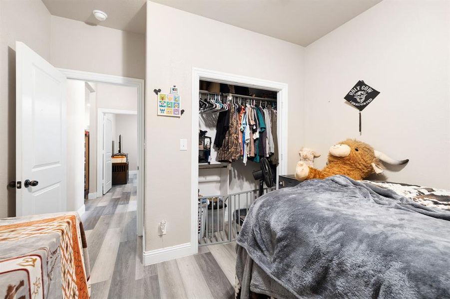 Bedroom featuring light wood-type flooring and a closet