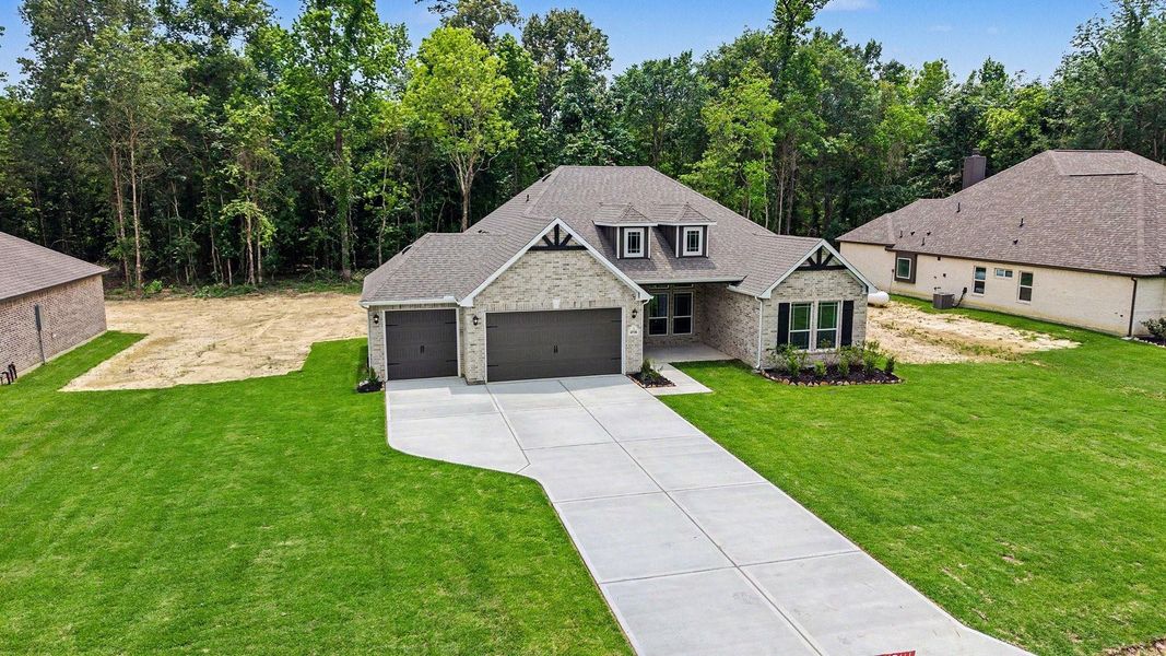 Front exterior of a new home in Encino Estates, Dayton, TX, highlighting curb appeal (Image 20).