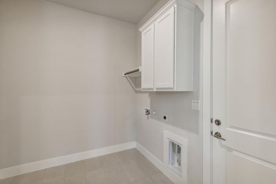 Washroom featuring cabinets, hookup for a washing machine, and electric dryer hookup